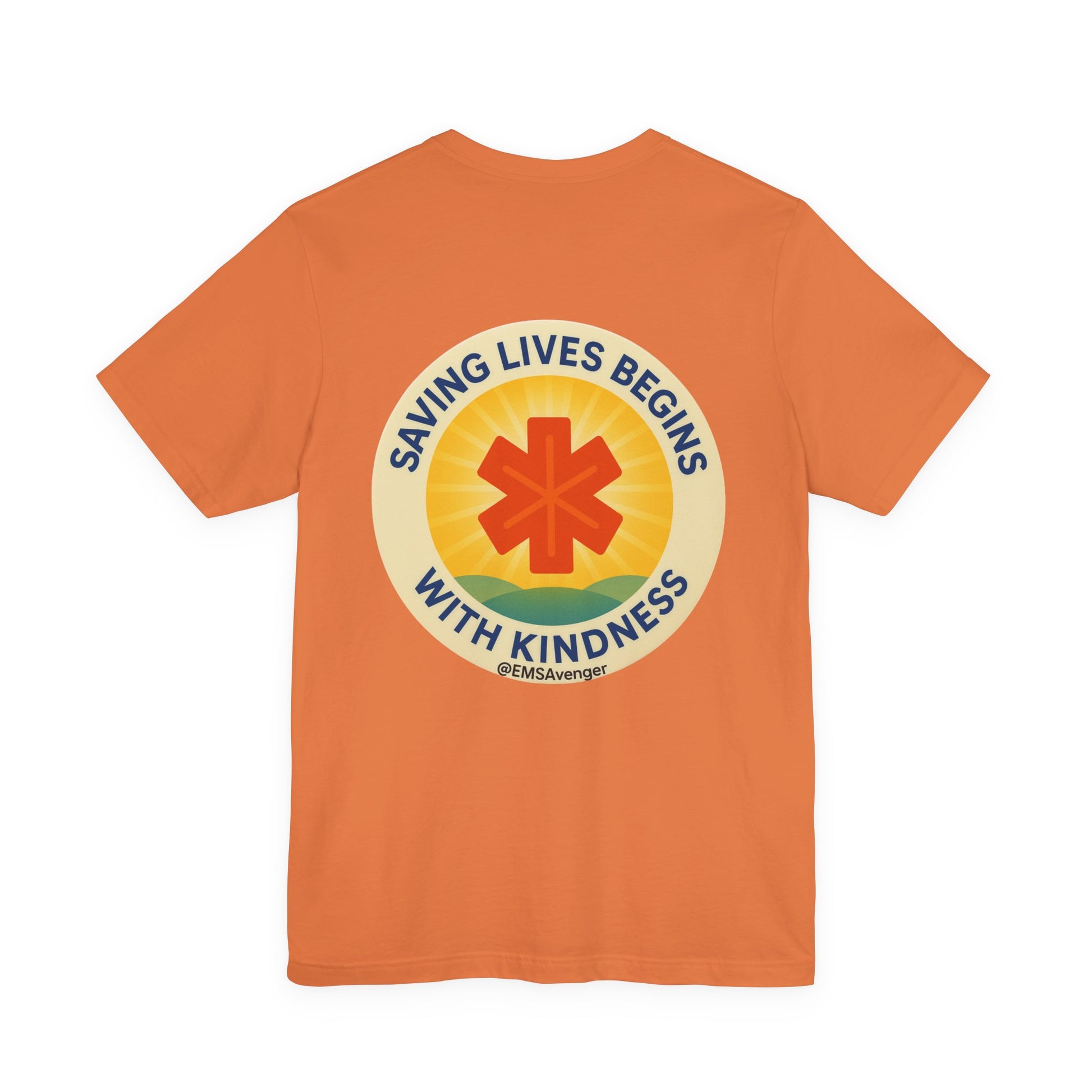 Orange t-shirt with a circular design featuring a star of life symbol and text "Saving lives begins with kindness, EMS Avenger" on the back, on a white background.
