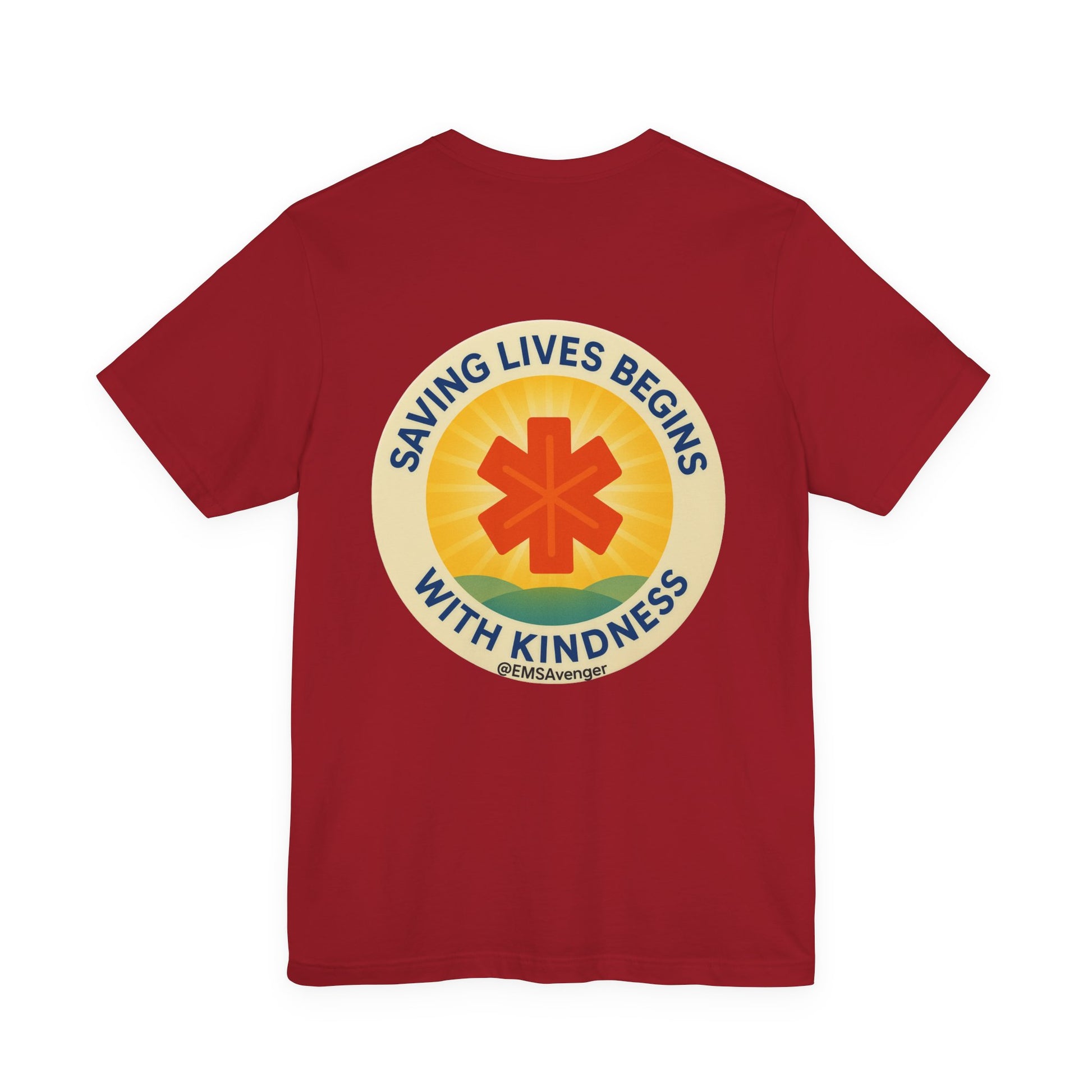 Red t-shirt with a circular design featuring a star of life symbol and text "Saving lives begins with kindness, EMS Avenger" on the back, on a white background.