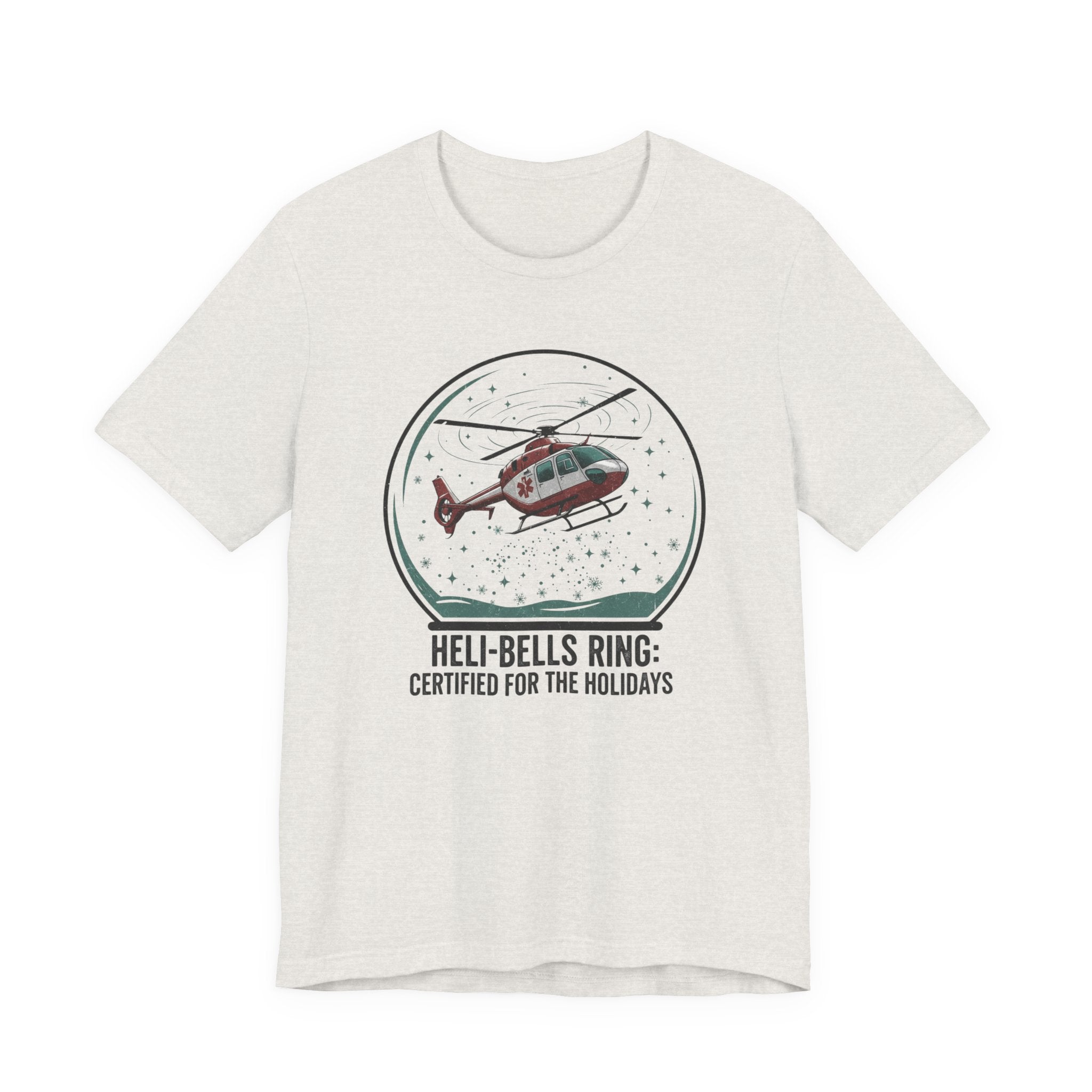 Heather cement t-shirt with a graphic of a helicopter in a snow globe and text "Heli-bells ring: certified for the holidays" by Rotor Wash & Wear