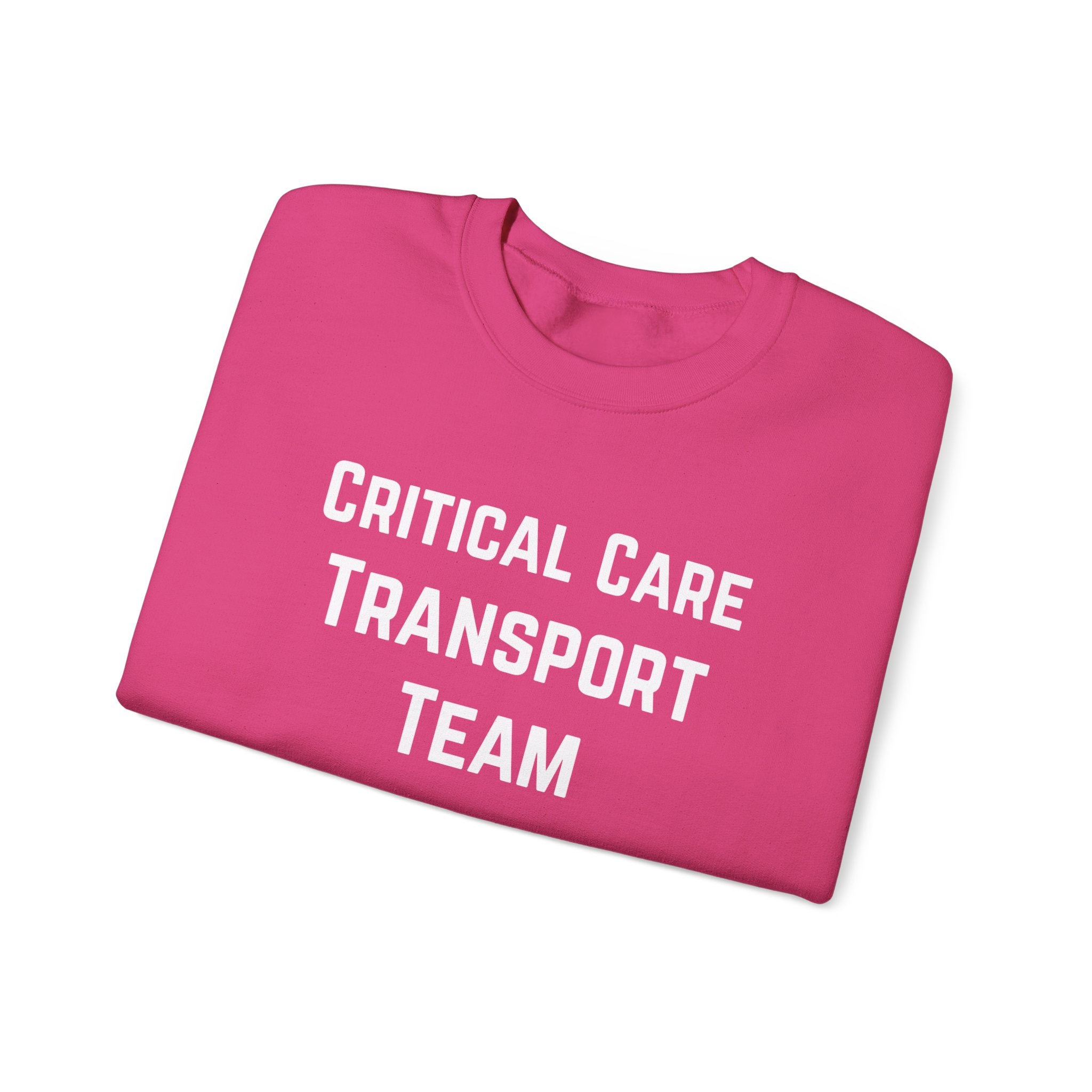 Folded pink sweatshirt with 'Critical Care Transport Team' text by Rotor Wash & Wear