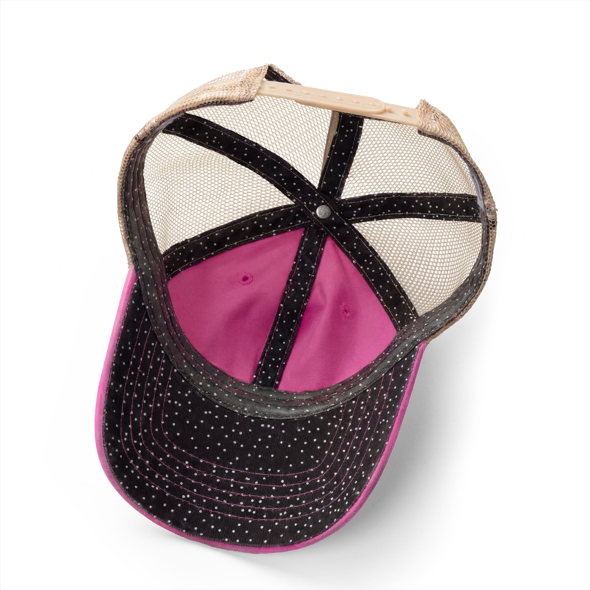 Baseball cap with black spotted brim, pink interior, and beige mesh back on a white background