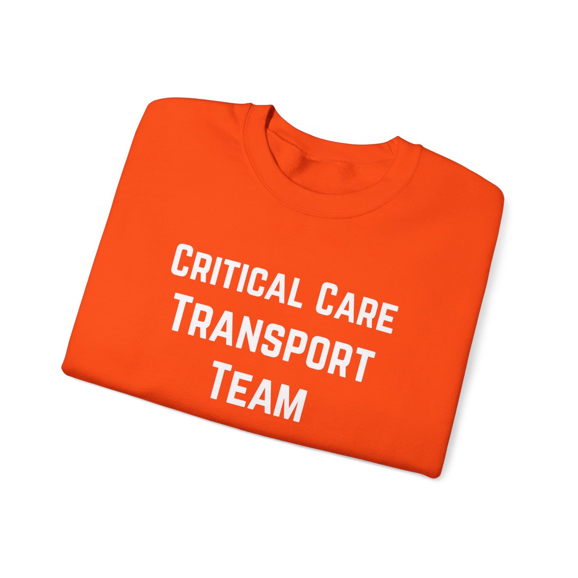 Folded orange sweatshirt with 'Critical Care Transport Team' text by Rotor Wash & Wear