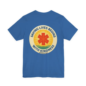 Blue t-shirt with a circular design featuring a star of life symbol and text "Saving lives begins with kindness, EMS Avenger" on the back, on a white background.
