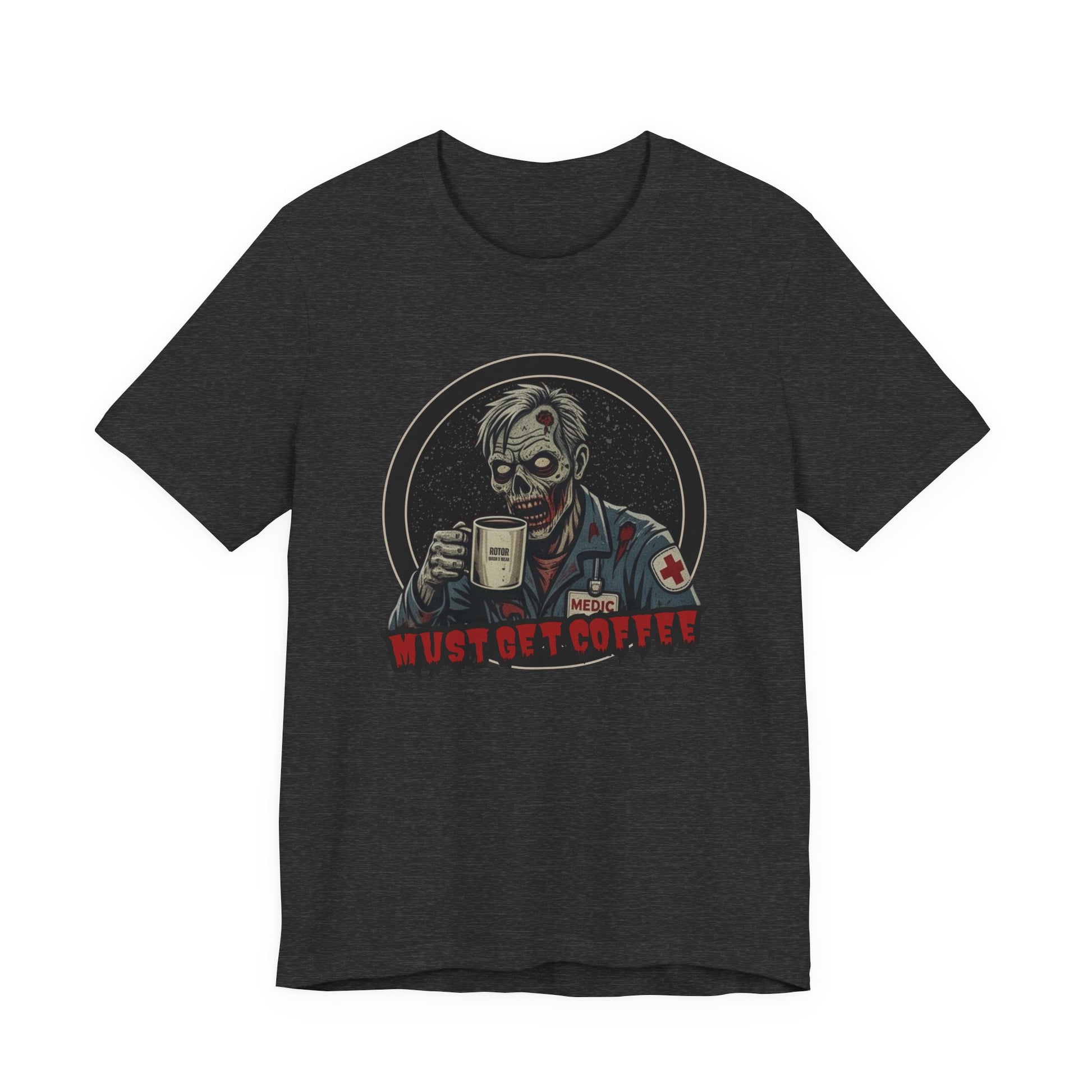 A dark heather gray crewneck t-shirt featuring a graphic of a zombie medic holding a coffee mug with the text 'MUST GET COFFEE!' in red by Rotor Wash & Wear