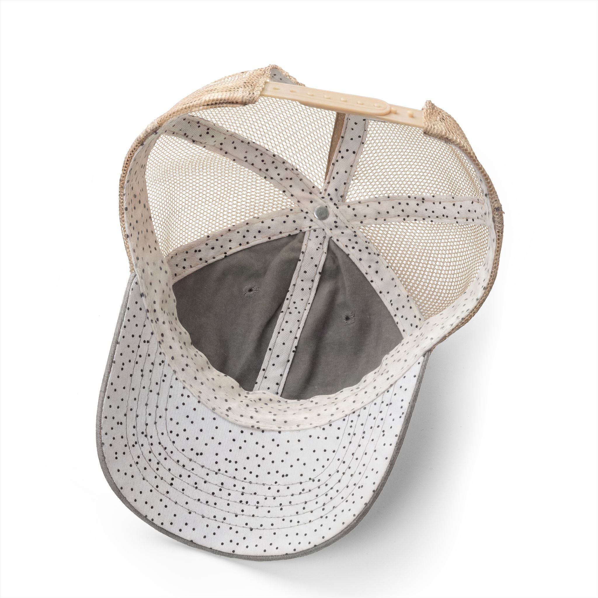 Baseball cap with mesh back and polka dot interior pattern on a white background
