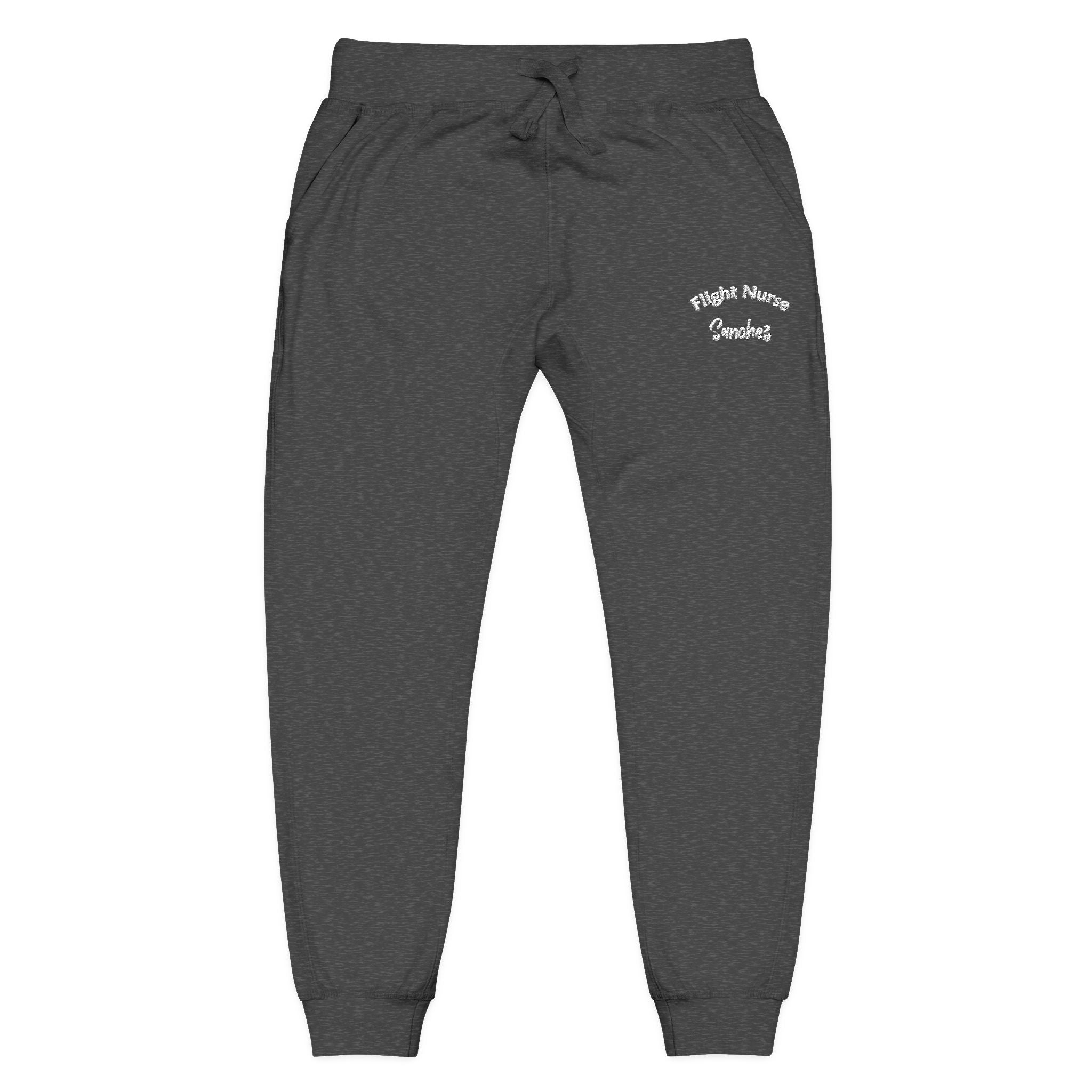 Dark gray joggers with embroidered &#39;Flight Nurse Sanchez&#39; text on the thigh against a white background
