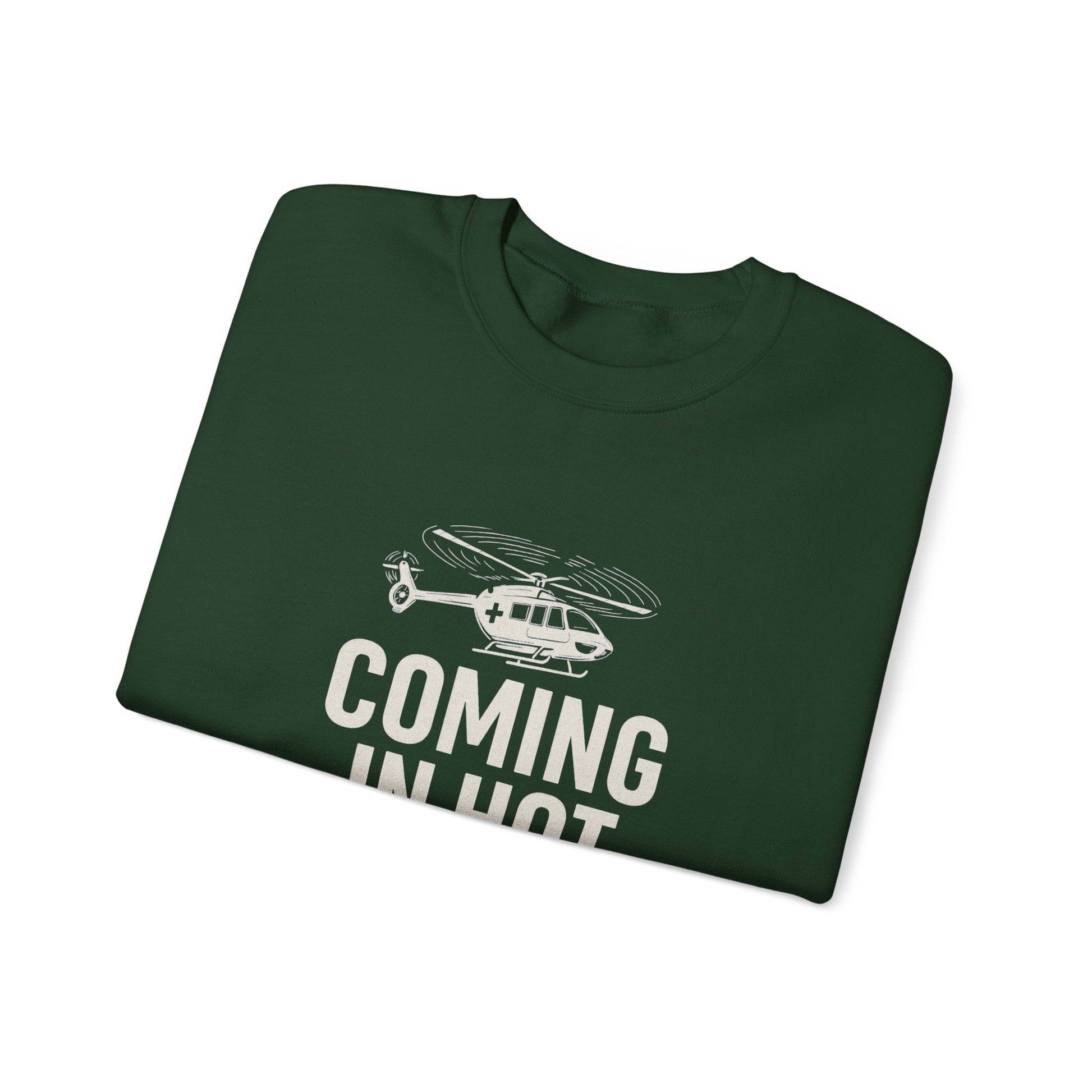 Folded green sweatshirt with helicopter graphic and text 'COMING IN HOT' by Rotor Wash & Wear