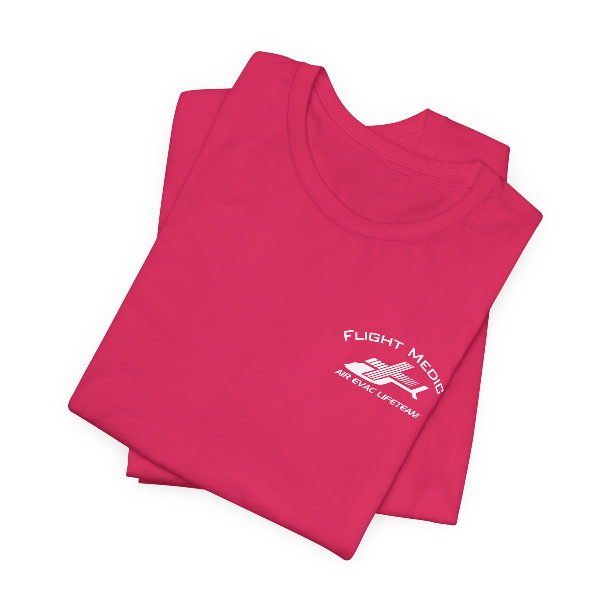 Folded pink t-shirt with small 'Flight Medic" text and Air Evac Lifeteam' logo on the left chest by Rotor Wash & Wear