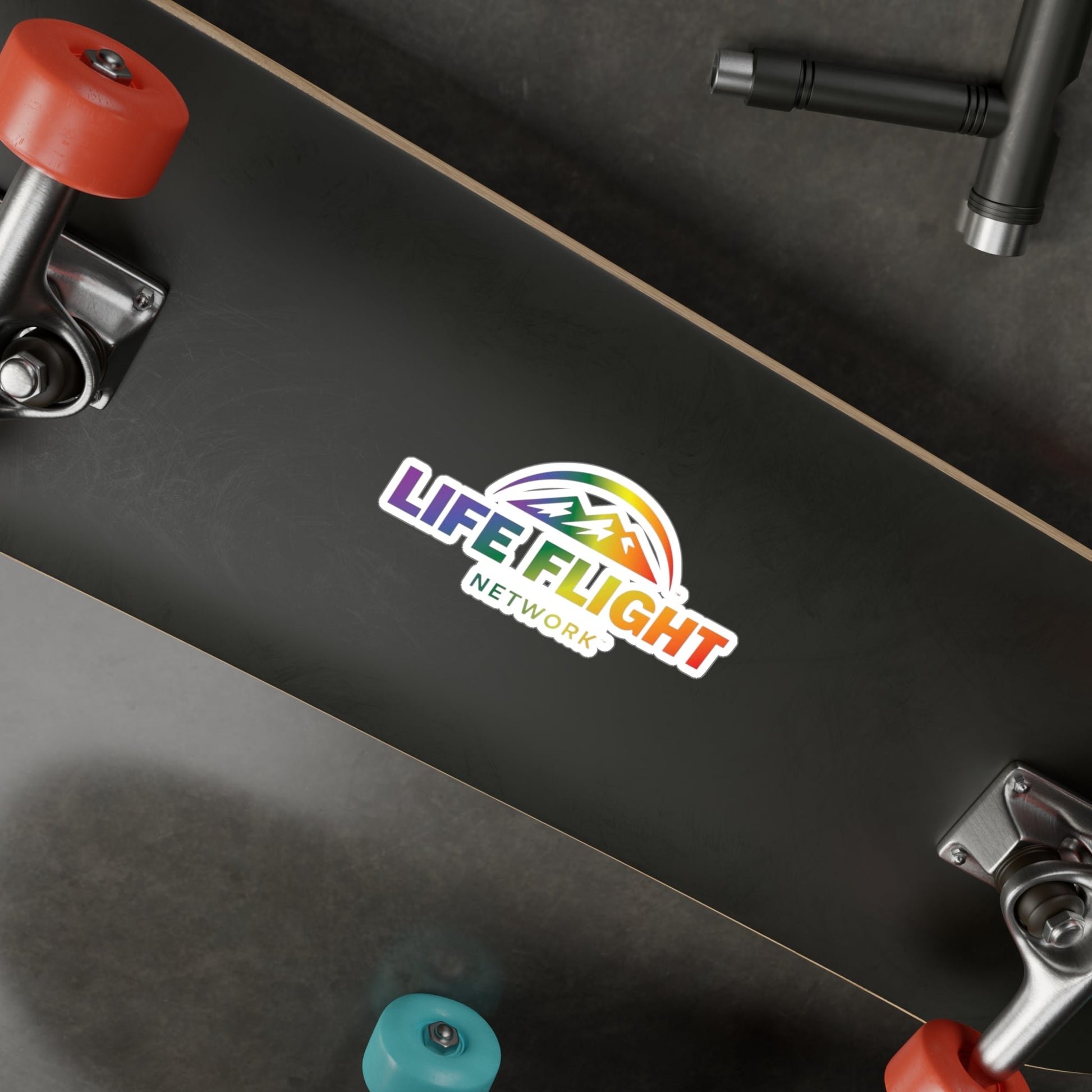 Black skateboard with Life Flight Network rainbow logo