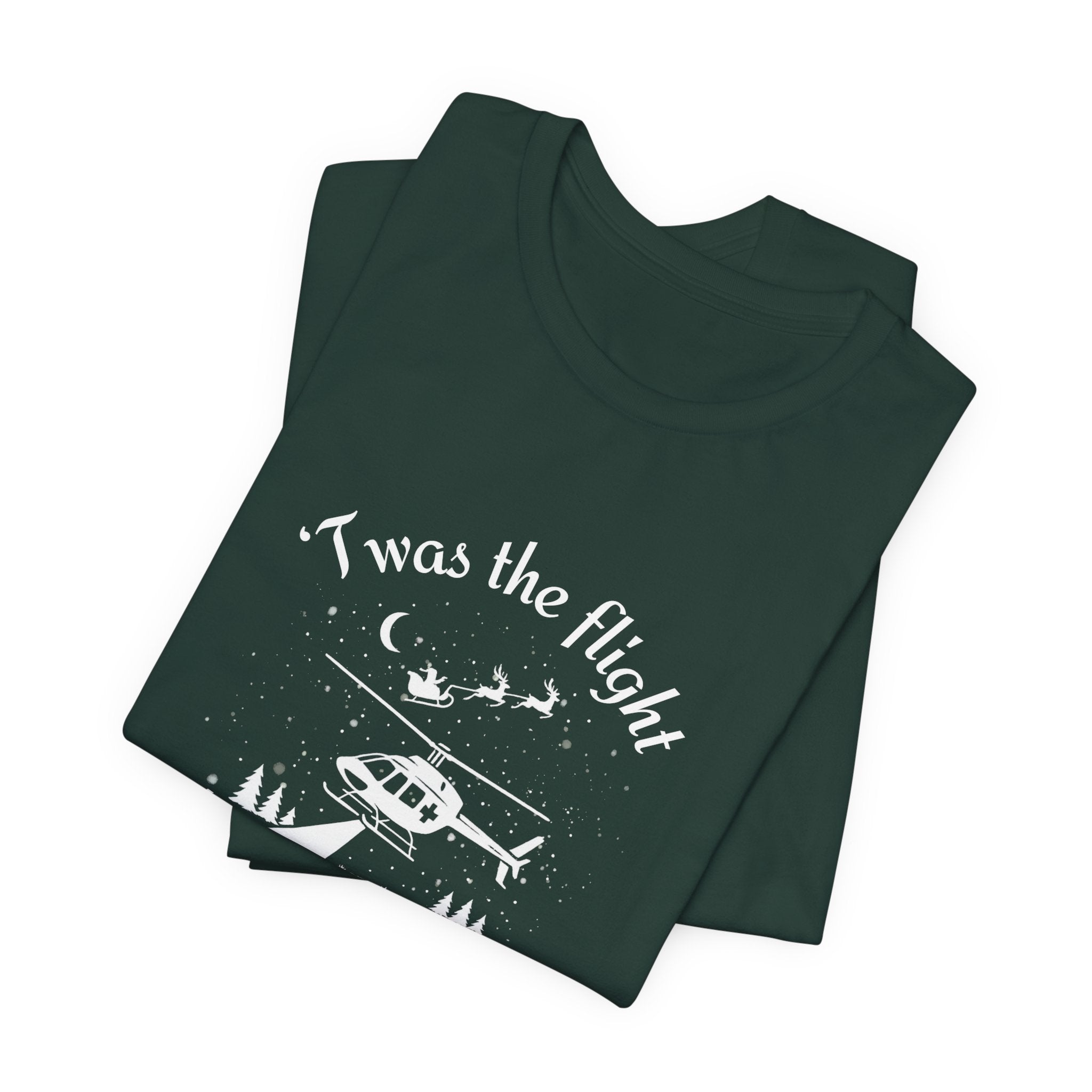 Folded dark green t-shirt with helicopter graphic and Santa and his sleigh in the background with text "'Twas the flight before Christmas" by Rotor Wash & Wear