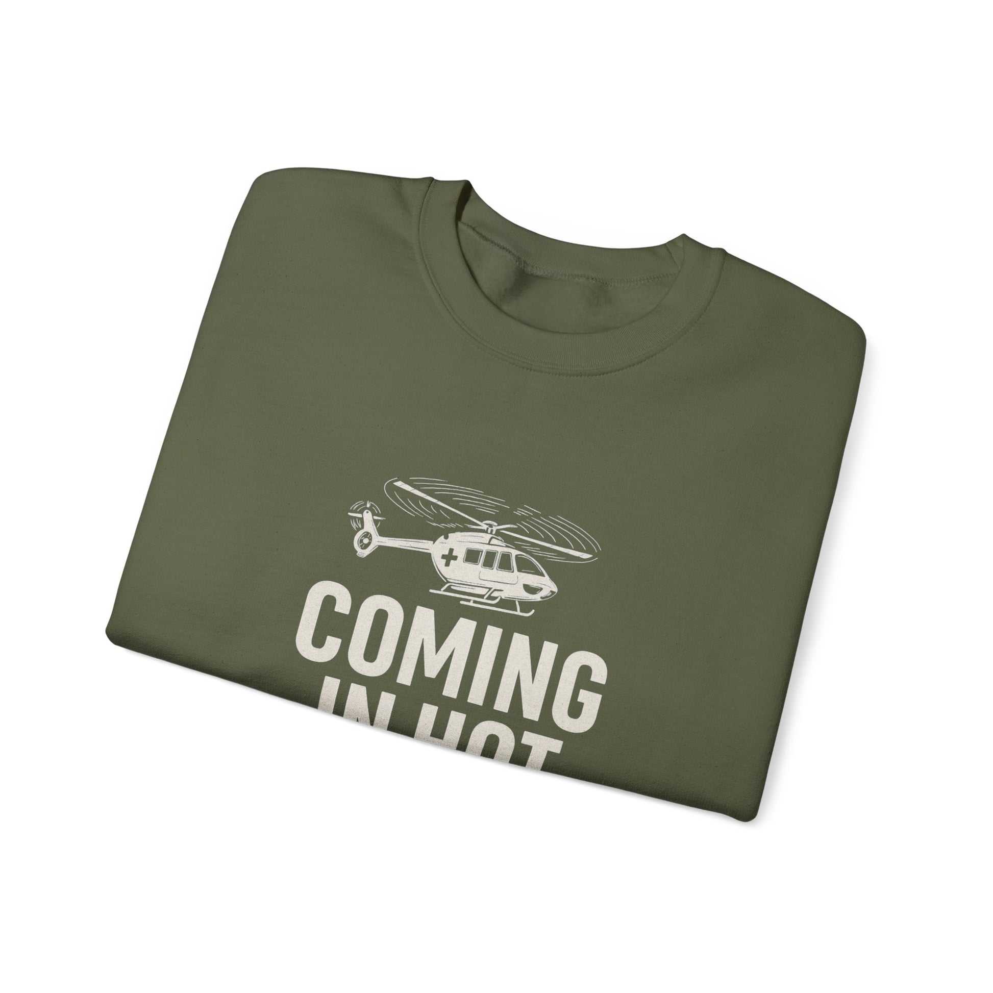 Folded green sweatshirt with helicopter graphic and text 'COMING IN HOT' by Rotor Wash & Wear