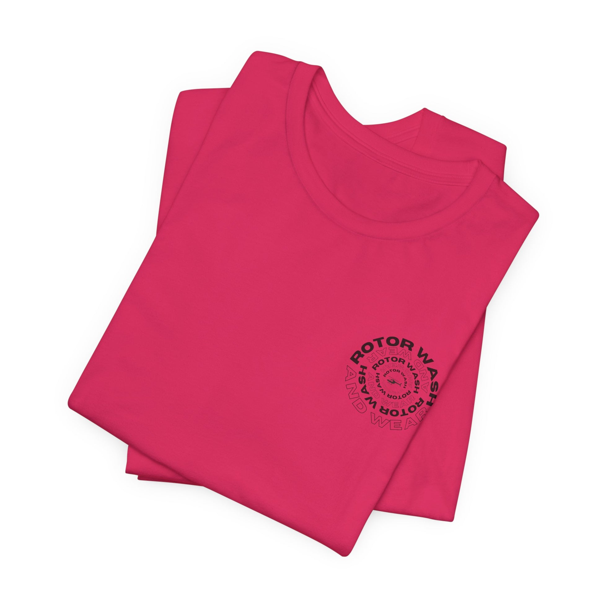 Folded pink t-shirt with 'Rotor Wash and Wear' circular design text design on the left chest on a white background