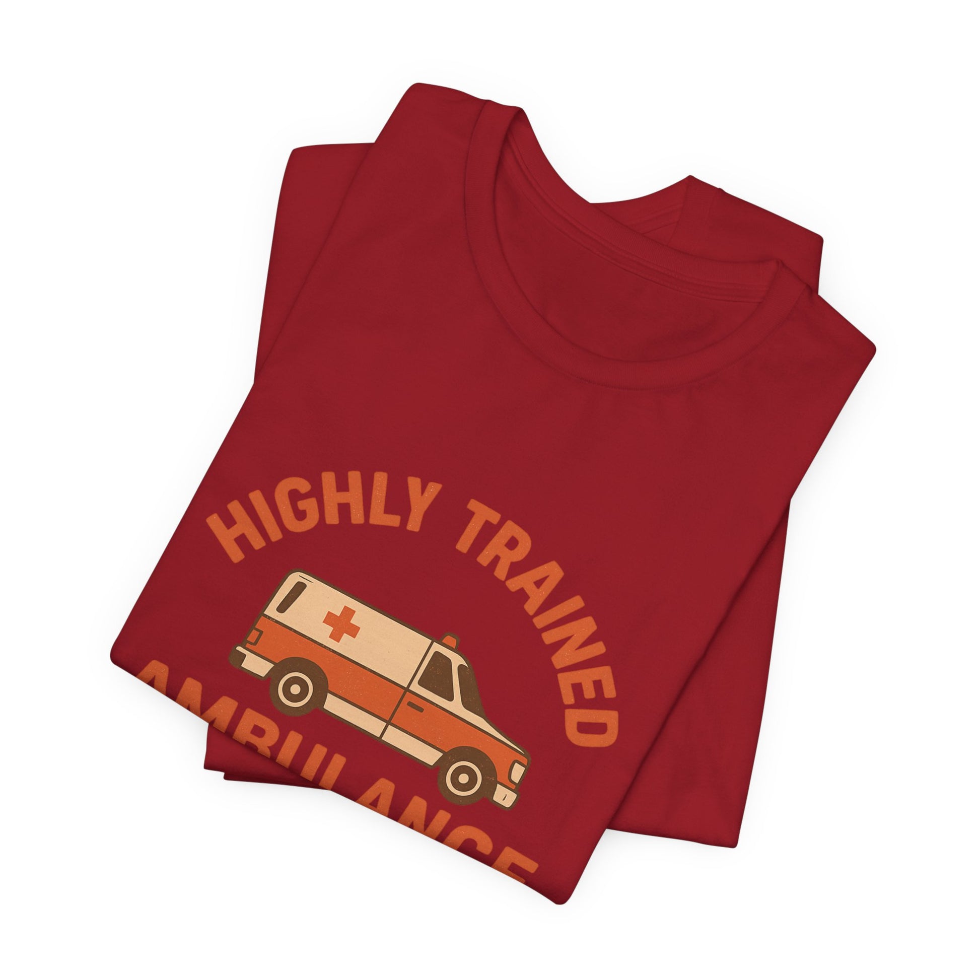 Folded red t-shirt with 'Highly Trained Ambulance' graphic on a white background