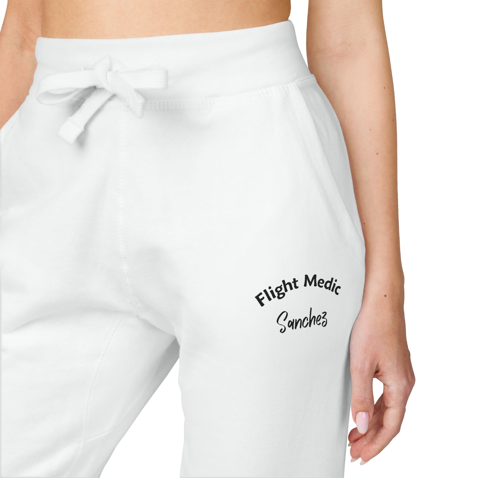 White joggers with text "Flight Medic Sanchez" on a white background
