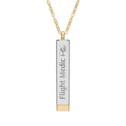 Silver and gold two-toned necklace with a cylindrical pendant engraved with 'flight medic' with hidden interior engraving "Fly Safe. Come home." by Rotor Wash & Wear