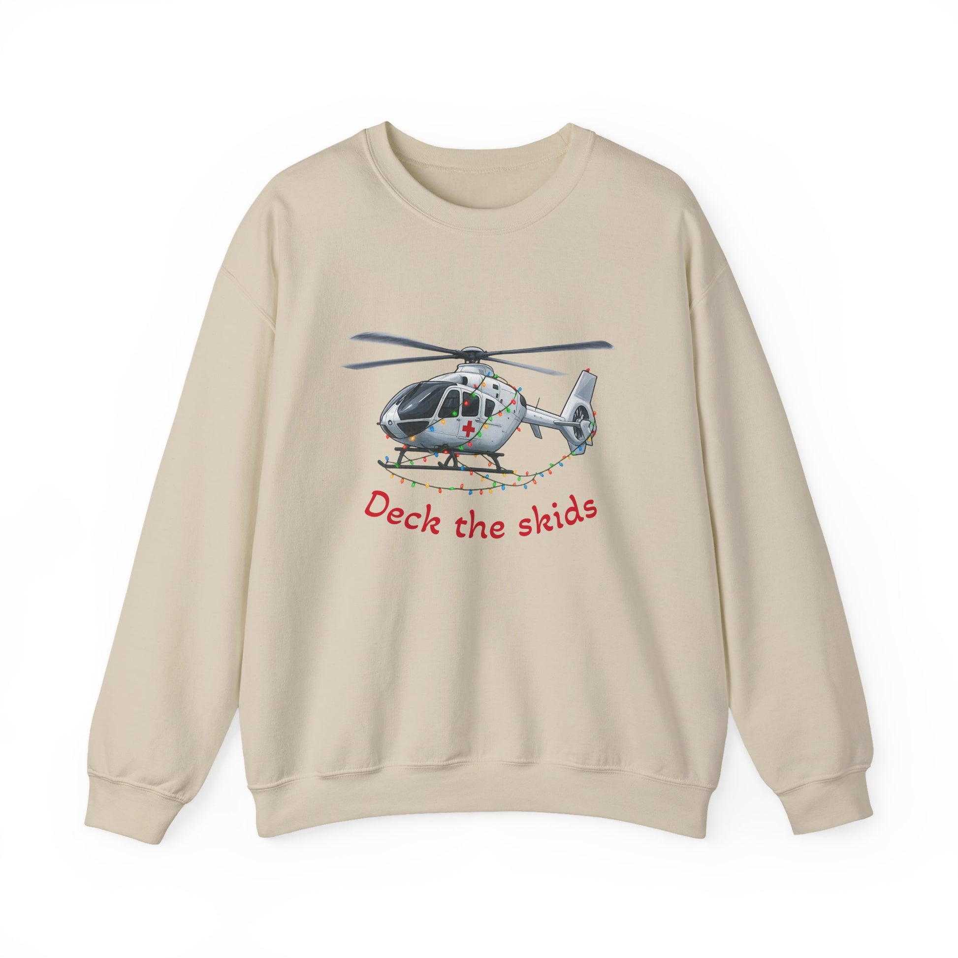 Beige sweatshirt with a medical helicopter graphic wrapped in Christmas lights and text "deck the skids" by Rotor Wash & Wear