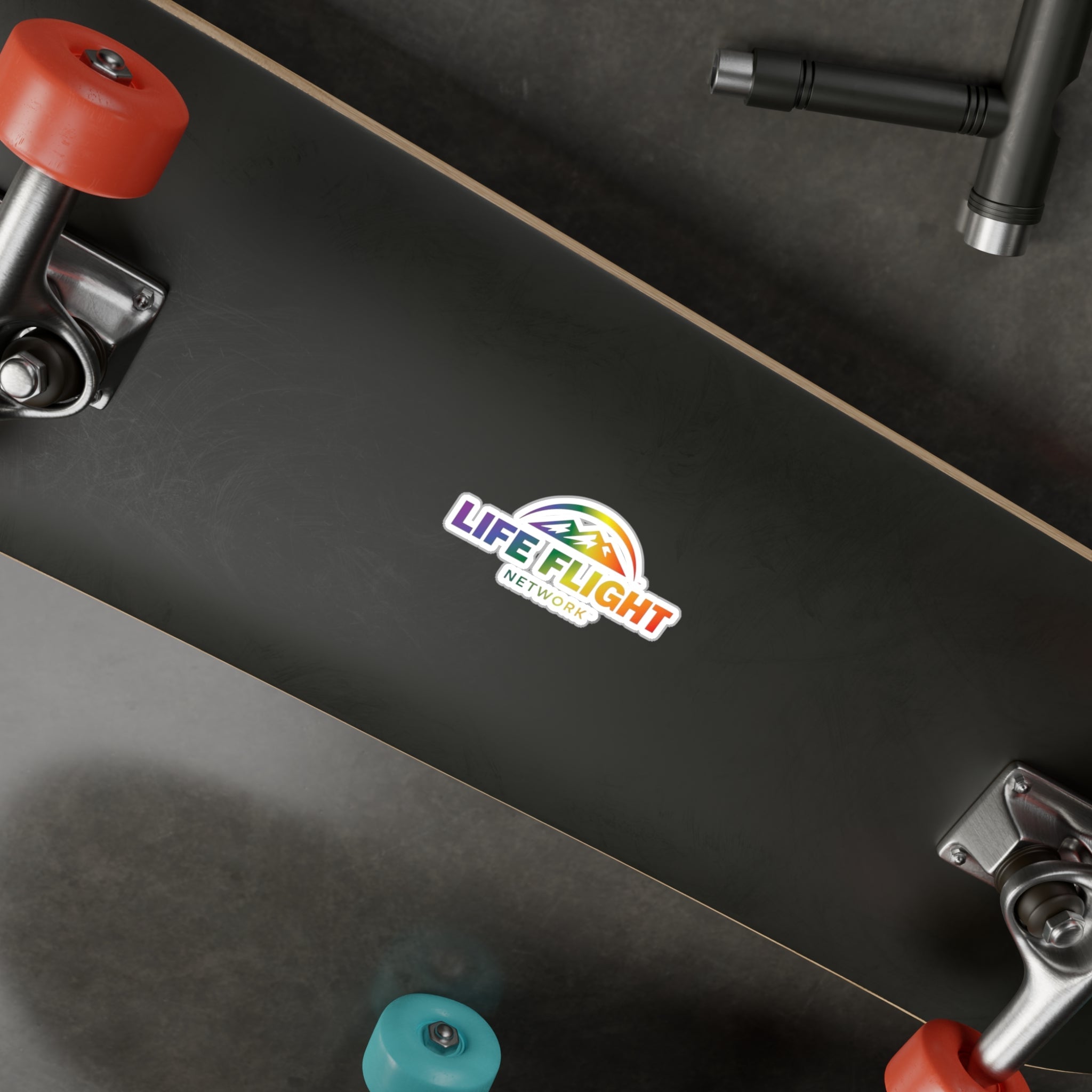 Black skateboard with Life Flight Network rainbow logo