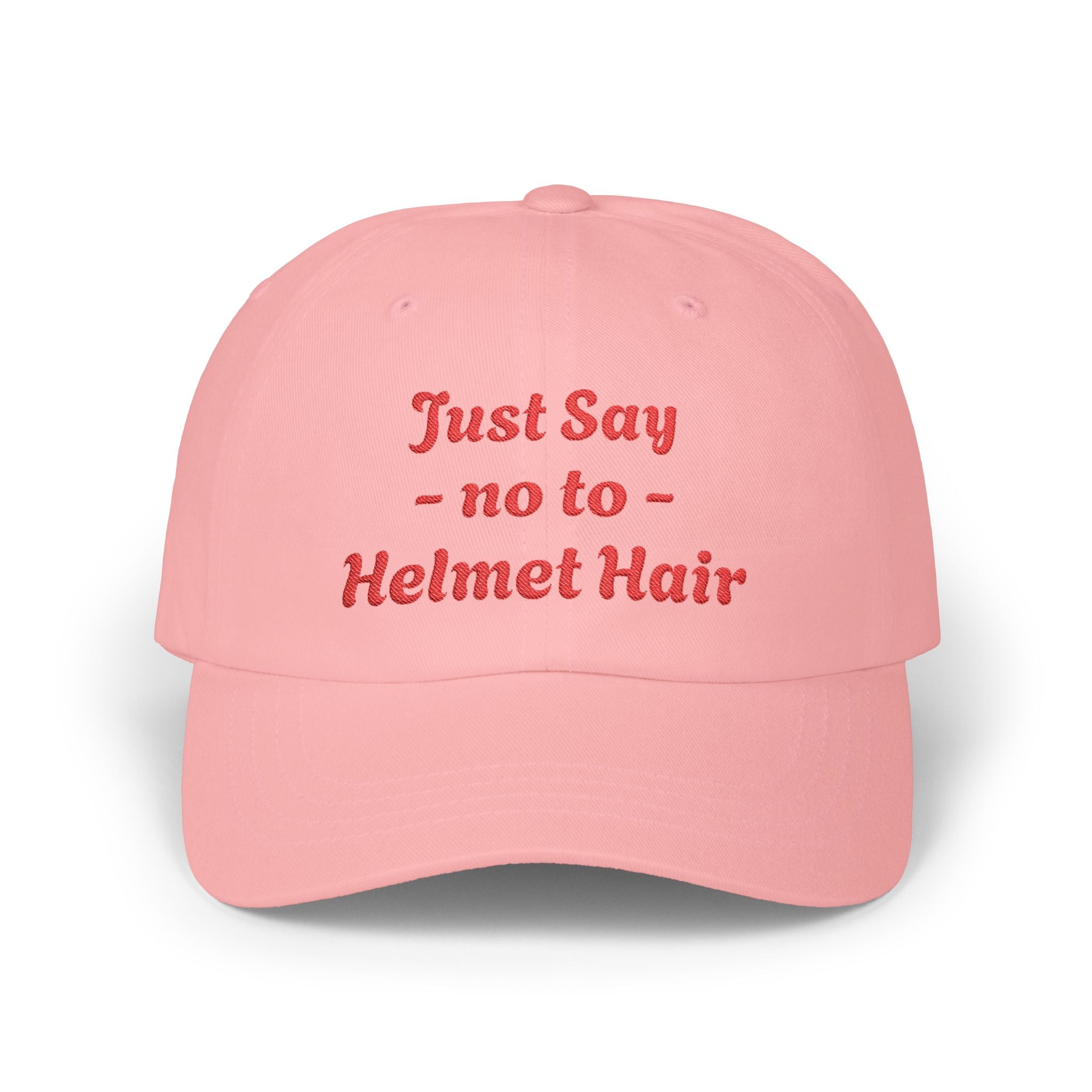 Pink cap with red text 'Just Say no to Helmet Hair' on a white background