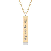 Silver and gold two-toned necklace with a cylindrical pendant engraved with 'sky medic' with hidden interior engraving "What's your superpower?" by Rotor Wash & Wear