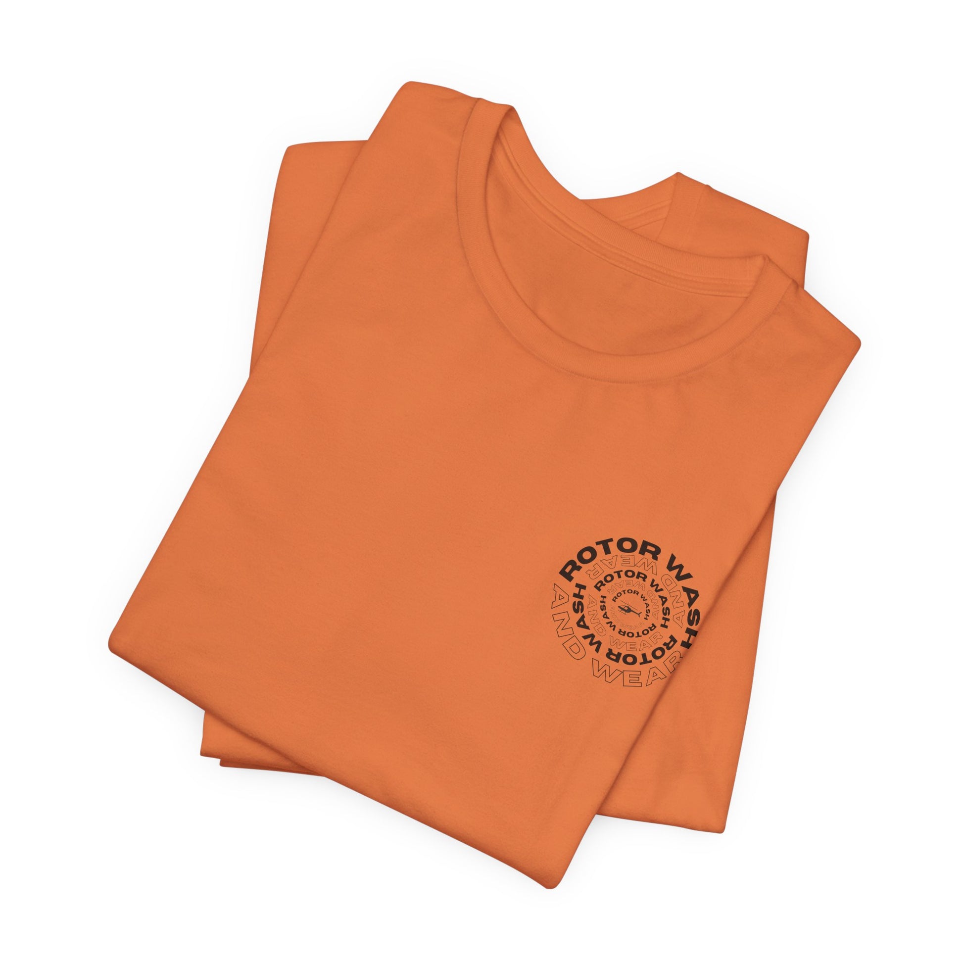Folded orange t-shirt with 'Rotor Wash and Wear' circular design text design on the left chest on a white background