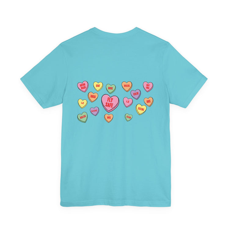 Light blue t-shirt with colorful conversation hearts with medical flight sayings by Rotor Wash & Wear