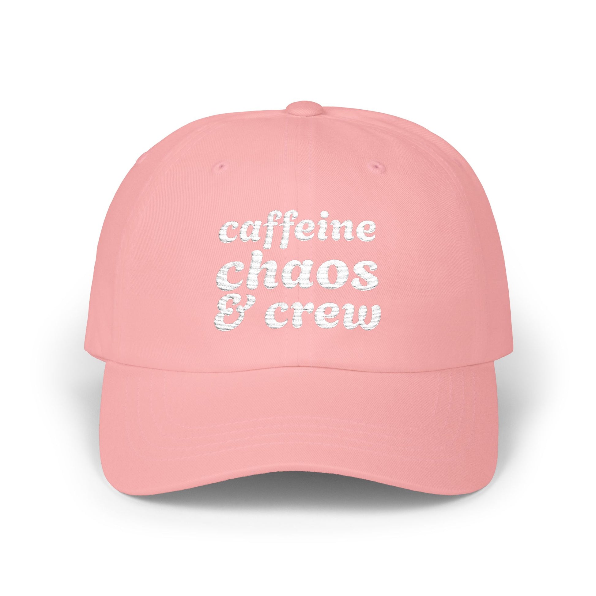 Pink cap with 'cafeine chaos & crew' text on a white background