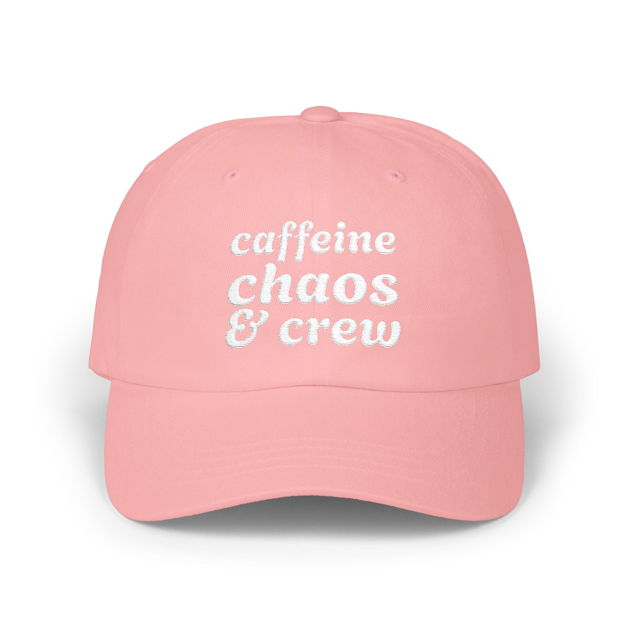 Pink cap with 'cafeine chaos & crew' text on a white background