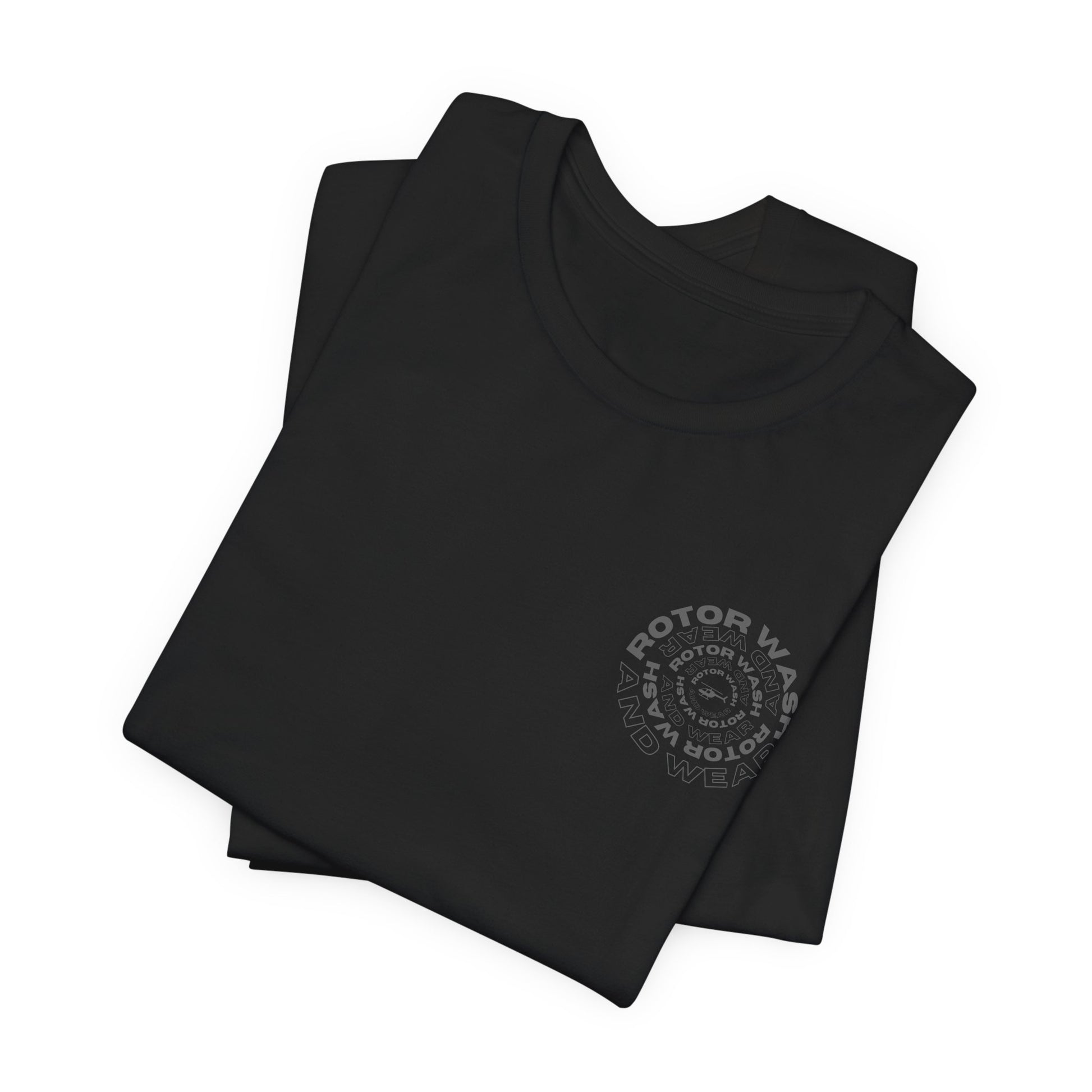 Folded black t-shirt with 'Rotor Wash and Wear' circular design text design on the left chest on a white background