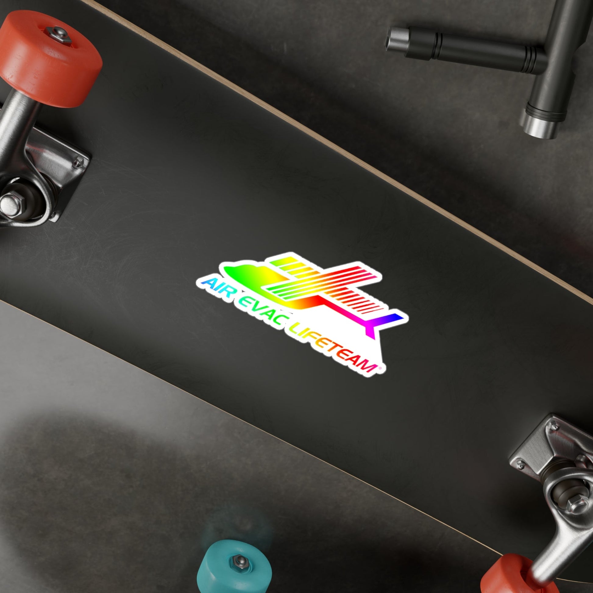 Colorful sticker with text "Air Evac Lifeteam" on a black skateboard deck