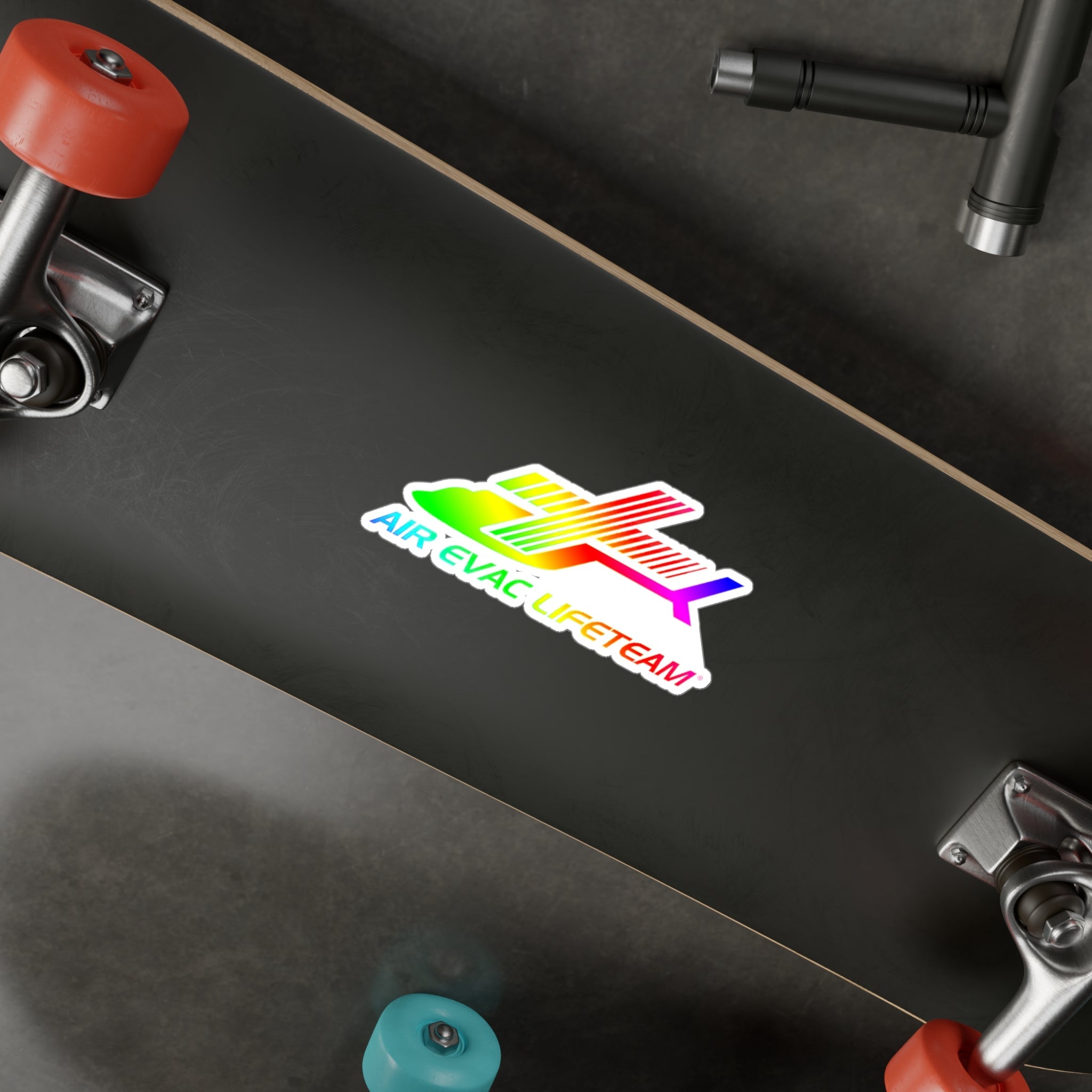 Colorful sticker with text "Air Evac Lifeteam" on a black skateboard deck