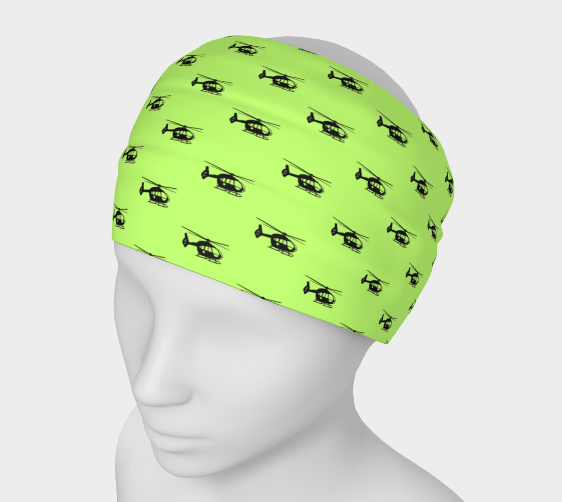 Lime green headband with helicopter pattern on a mannequin head against a white background