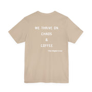 Beige t-shirt with white text "We thrive on chaos & coffee, the flight crew" on a white background