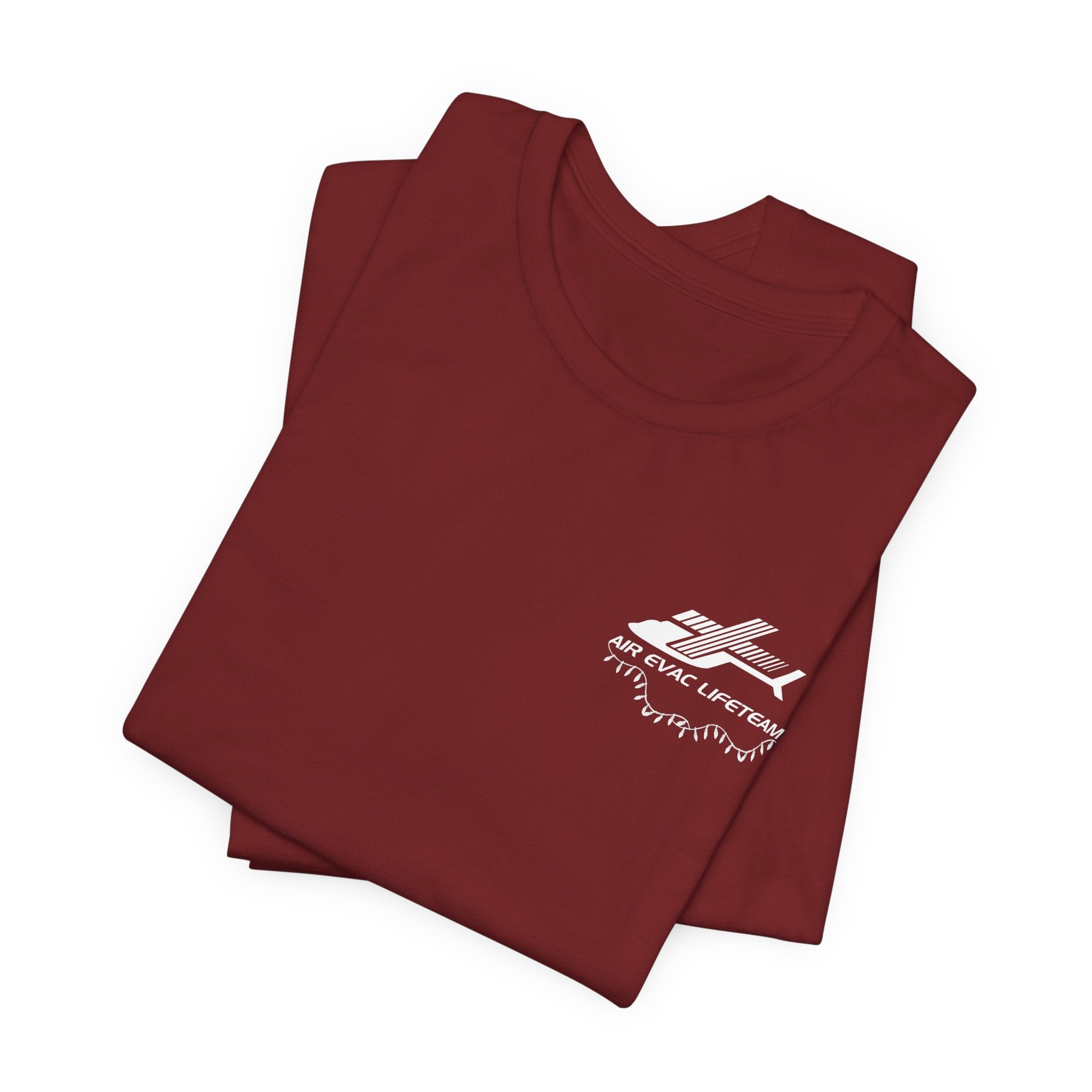 Folded dark red  t-shirt with a white Air Evac logo and Christmas lights on a white background