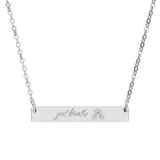 Silver necklace with 'just breathe' text and lung vasculature engraving by Rotor Wash & Wear