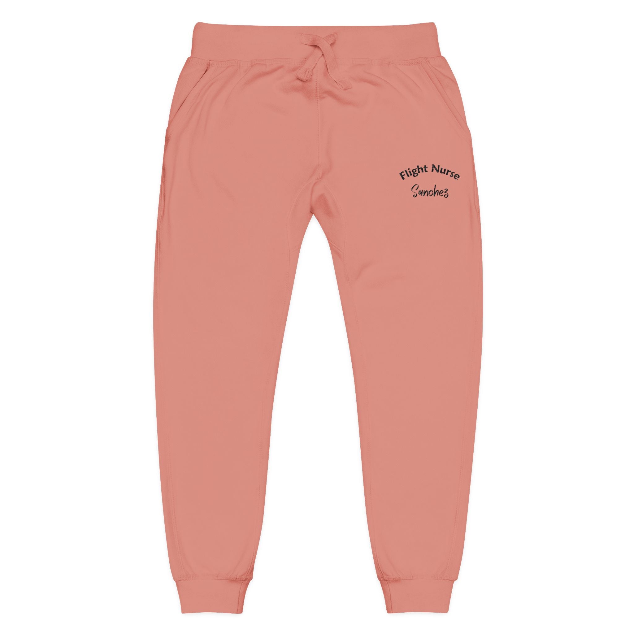 Pink joggers with embroidered &#39;Flight Nurse Sanchez&#39; text on the thigh against a white background