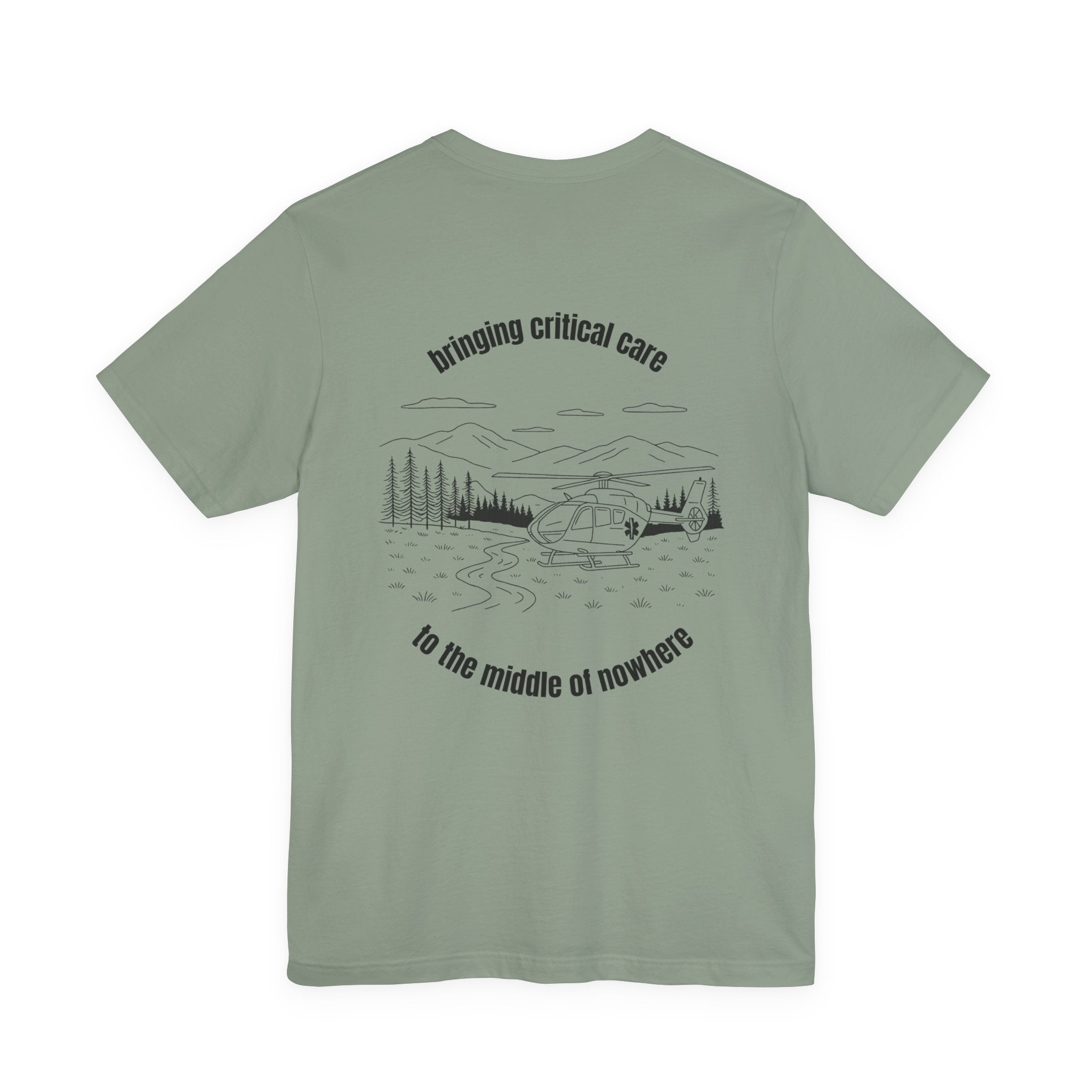 Sage green t-shirt with a helicopter graphic and text &quot;bringing critical care to the middle of nowhere&quot; on the back, displayed on a white background.