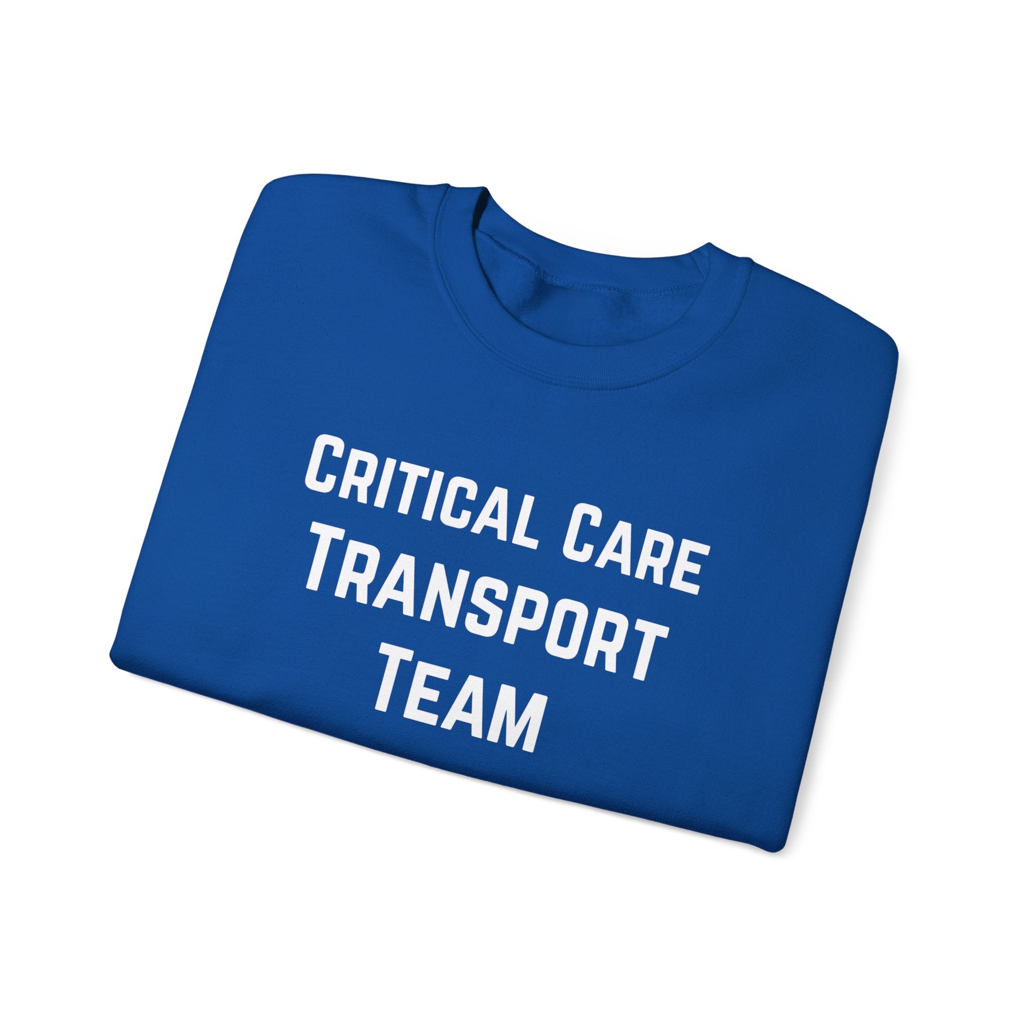 Folded blue sweatshirt with 'Critical Care Transport Team' text by Rotor Wash & Wear
