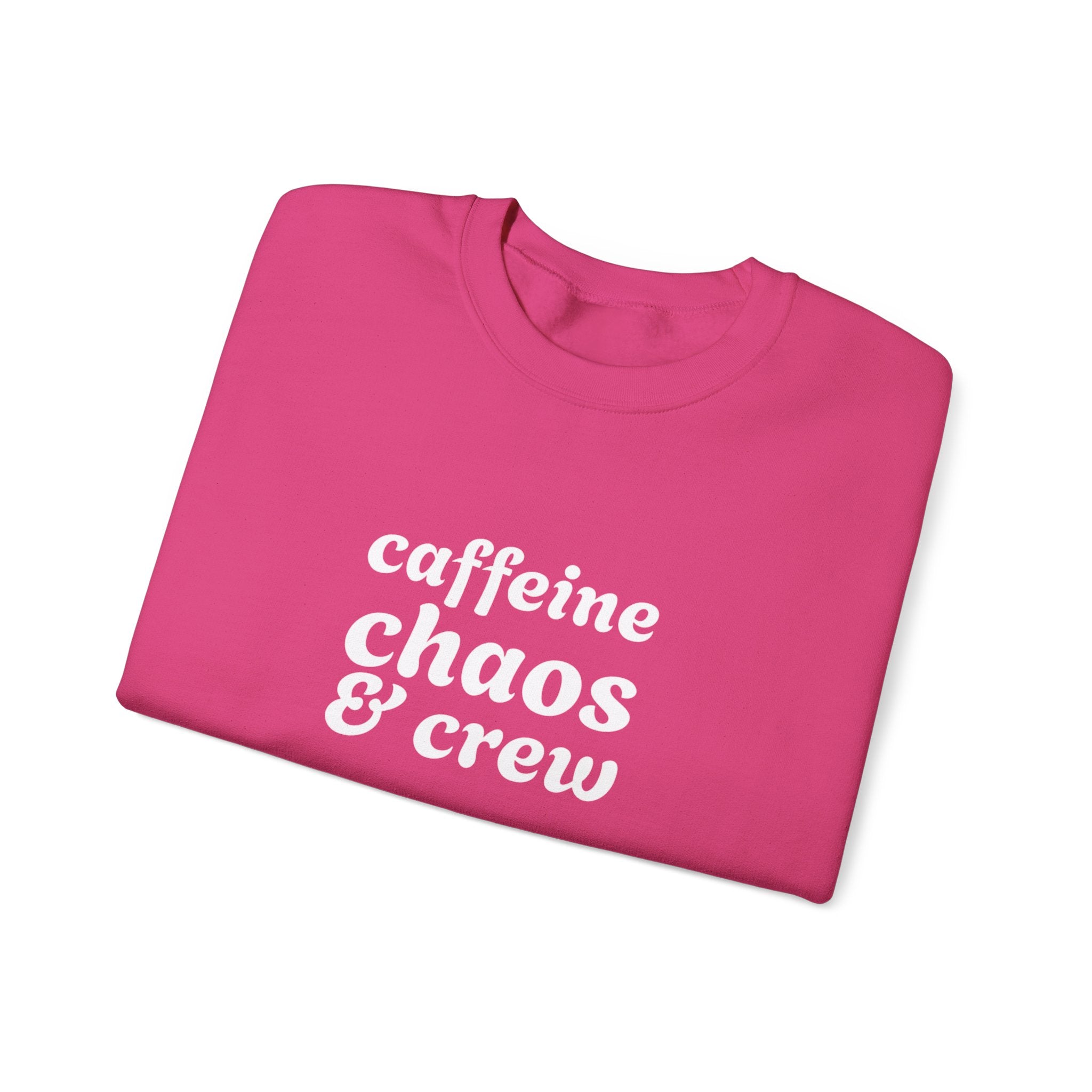 Folded pink sweatshirt with 'caffeine chaos & crew' text on by Rotor Wash & Wear