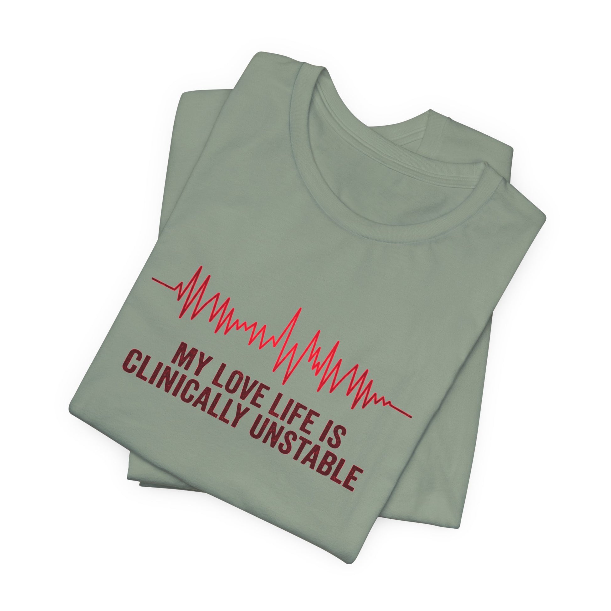 Folded sage green t-shirt ventricular fibrillation cardiac rhythm and text "My love life is clinically unstable" by Rotor Wash & Wear