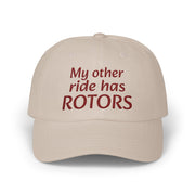 Beige cap with red text 'My other ride has ROTORS' on a white background