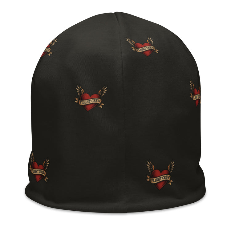 Dark gray beanie with American traditional tattoo heart with wings with ribbon and text "flight crew" with all over print by Rotor Wash & Wear