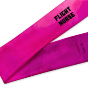 Hot pink head band with black text "flight nurse" by Rotor Wash & Wear