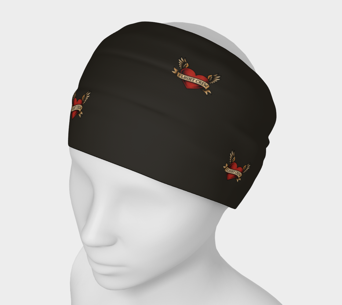 Black headband with heart and arrow designs and text "flight crew" on a mannequin head against a white background